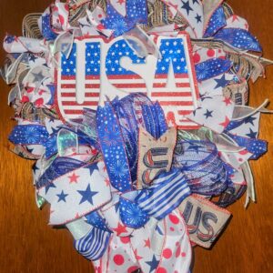 Patriotic USA wreath with red, white, and blue ribbons and large USA sign in center