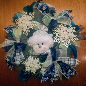 Handmade blue and white snowman winter wreath decorated with large sparkling snowflakes and layered winter ribbons.