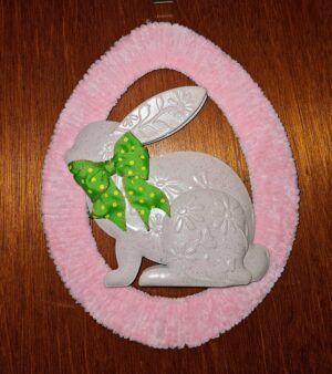 Handmade pink oval Easter wreath featuring a beige embossed bunny with green polka dot bow.