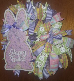Large 24x22 handmade Happy Easter bunny wreath with lavender bunny sign, pastel ribbons, plaid and striped accents, and spring mesh on a front door.