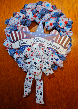 God Bless America wreath with star and hearts centerpiece and red white blue ribbon pouf design