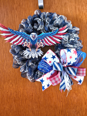Large patriotic bald eagle wreath with American flag wings on navy deco mesh base with stars and stripes bow
