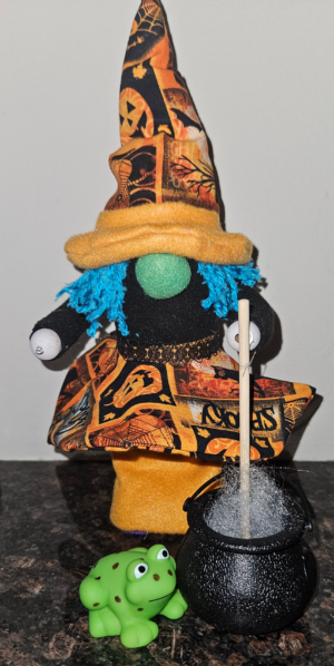 Handmade Halloween witch gnome with blue hair, orange and black hat, cauldron and green frog
